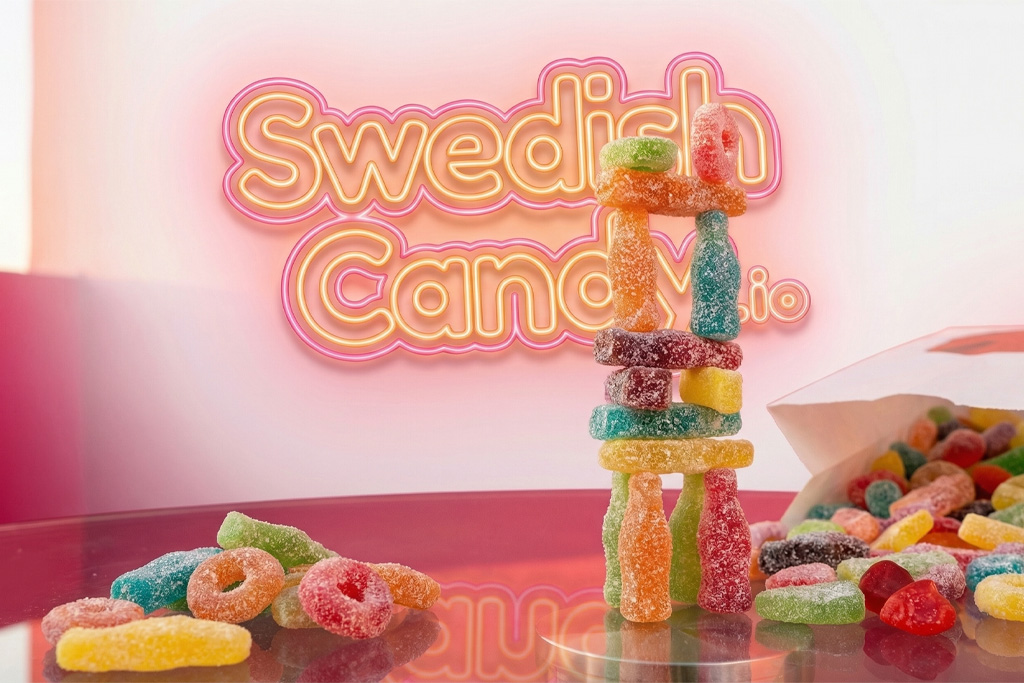 Colorful Swedish gummy candies stacked in a tower, with a pink neon Swedish Candy sign in the background