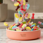 Assorted Swedish pick-and-mix candy in a bowl, a build-your-own lösgodis mix with gummies, skulls and sour candies