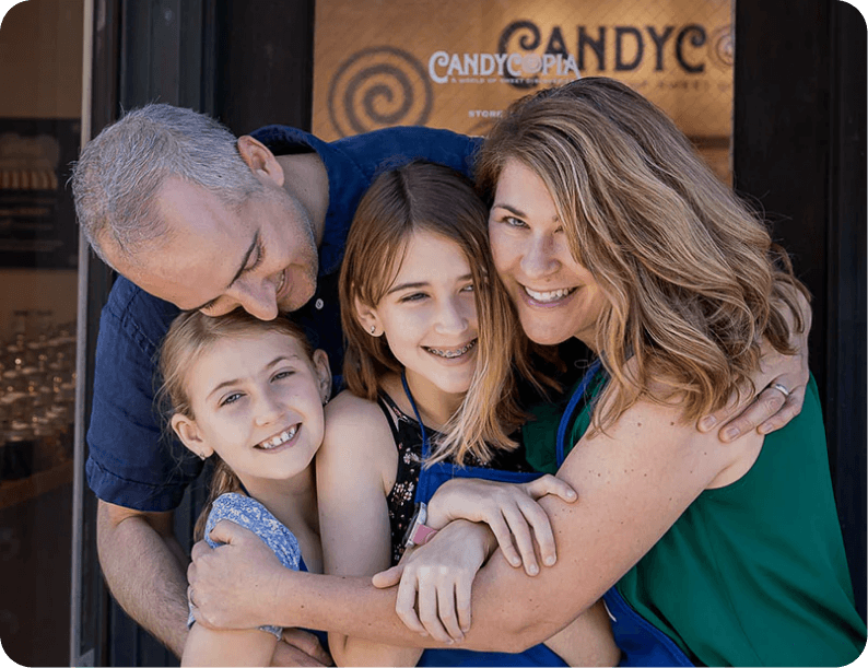 Family standing outside the Candycopia Swedish candy storefront in Oak Park, Illinois